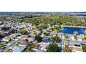 Aerial view of houses, streets, and a pond at 2446 Leaning Pine Ln, Oviedo, FL 32765