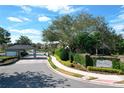 Gated community entrance with a guardhouse and landscaping at 2511 Madron Ct, Orlando, FL 32806