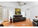 Living room with hardwood floors, leather couches, and a large piece of art at 2823 Cady Way, Winter Park, FL 32792