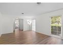 Bright living room with natural light, wood floors, and access to a bedroom at 2823 Cady Way, Winter Park, FL 32792