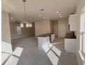 Modern kitchen featuring white cabinets, granite countertops, and an island at 3019 Tackle Drive, Leesburg, FL 34748