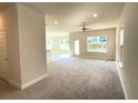 Bright and spacious living room with neutral carpeting and access to backyard at 3019 Tackle Drive, Leesburg, FL 34748