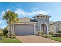 Gray house with a two-car garage and nicely landscaped yard at 308 Vestrella Dr, Kissimmee, FL 34759