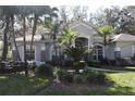 Two-story home with stone accents and lush landscaping at 3663 Lomond Ct, Apopka, FL 32712