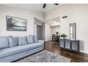 Living room with gray couch, dark wood floors, and dining area at 3756 Idlebrook Cir # 206, Casselberry, FL 32707