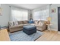 Bright living room featuring a sectional sofa, ottoman, and stylish rug at 4304 Mizell St, Orlando, FL 32812