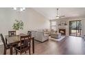 Spacious living room with L-shaped sofa, fireplace, and wood-look floors at 447 Stanton Pl, Longwood, FL 32779