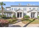 Front view of a two-story townhome with gray siding and walkway at 5159 Wellington Park Cir # 36, Orlando, FL 32839