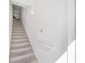 Indoor view of carpeted staircase with white walls and railing at 5159 Wellington Park Cir # 36, Orlando, FL 32839