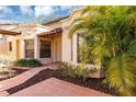 Front entrance with terracotta tile walkway and palm trees at 706 Santa Cruz Ln, Howey In The Hills, FL 34737