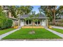 Modern duplex with stone facade and lush green lawn at 806 Palmer St, Orlando, FL 32801