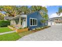 Newly built home with blue siding and a large driveway at 806 Palmer St, Orlando, FL 32801