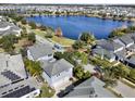 Two-story house with gray exterior, solar panels, and a large backyard near a lake at 8758 Pinter St, Orlando, FL 32827