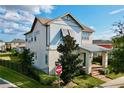 Two-story house with gray siding, metal roof, and a welcoming front porch at 9062 Sperry St, Orlando, FL 32827