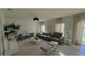 Spacious living room featuring a stylish sectional sofa and decorative wall accents at 376 Willet St, Haines City, FL 33844