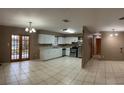 Kitchen features white cabinets, stainless steel appliances, and tile flooring at 1218 Russell Dr, Ocoee, FL 34761