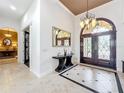 Spacious foyer featuring a console table and double doors at 12812 Jacob Grace Ct, Windermere, FL 34786