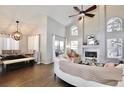 Spacious living room with vaulted ceilings, wood floors, a fireplace, and lots of natural light at 13111 Point O Wood Ct, Orlando, FL 32828