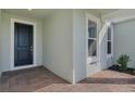 Front entrance with dark door and brick flooring at 13552 Autumn Harvest Ave, Winter Garden, FL 34787