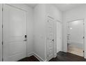 Bright entryway with wood-look floors, leading to bathroom and closet at 13556 Autumn Harvest Ave, Winter Garden, FL 34787