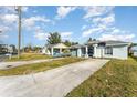 House with a green exterior, landscaping, and a basketball hoop at 1424 Sheridan Sw St, Winter Haven, FL 33880