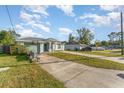 Landscaped yard with a one story house and basketball hoop at 1424 Sheridan Sw St, Winter Haven, FL 33880