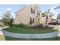 Two-story house with tan exterior, brown accents, landscaping, and a curved walkway at 1504 Oak Marsh Loop, Davenport, FL 33837