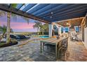 Covered patio with outdoor kitchen and dining area at 15863 Burch Island Ct, Winter Garden, FL 34787