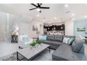 Spacious living room featuring a sectional sofa, coffee table, and access to the kitchen at 1611 Kona Ln, Davenport, FL 33897