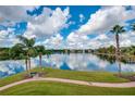 Serene lakefront view with walking path and fountain at 1910 Summer Club Dr # 110, Oviedo, FL 32765