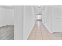 Bright hallway with tile flooring and doors leading to other rooms at 213 Lake Lucerne Way, Winter Haven, FL 33881