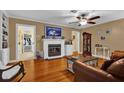 Inviting living room with hardwood floors, fireplace, a ceiling fan and a cozy atmosphere at 2250 W County Road 44, Eustis, FL 32726