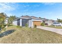 House exterior with a screened porch, attached garage, and well-maintained lawn at 2300 Grasmere View S Pkwy, Kissimmee, FL 34746