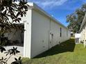 Side view of house showcasing garage and AC unit at 2523 Avalon Park Blvd, Tavares, FL 32778