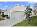 Attractive home exterior featuring a lush lawn and a two-car garage at 2523 Avalon Park Blvd, Tavares, FL 32778