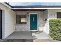 Teal front door and whitewashed brick exterior at 2779 Prince John Rd, Winter Park, FL 32792