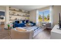 Bright living room featuring a blue sofa and large window at 2944 Moulin Rd, Davenport, FL 33837