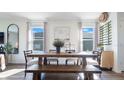 Farmhouse style dining area with wooden table and bench at 2977 Moulin Rd, Davenport, FL 33837