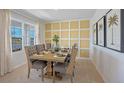 Bright dining room with yellow wall and a large wooden table with gray chairs at 2994 Salisbury Ave, Haines City, FL 33844