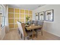 Elegant dining room features a yellow wall and a large wooden table with gray chairs at 2994 Salisbury Ave, Haines City, FL 33844