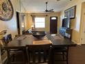 Dining area with a dark wood table and four chairs at 303 Cricket Hollow Ln, Eustis, FL 32726