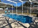 Relaxing kidney-shaped pool with a covered patio at 303 Cricket Hollow Ln, Eustis, FL 32726