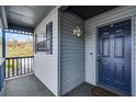 Front porch with a view and blue door at 313 Dirksen Dr # B16, Debary, FL 32713