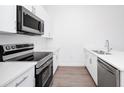 Modern kitchen with stainless steel appliances and white cabinets at 368 Famagusta Dr, Davenport, FL 33896