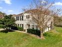 Two-story house with a brown roof, shutters, and landscaping at 413 Country Cottage Ln, Winter Garden, FL 34787