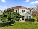 Two-story house with a brown roof, shutters, and landscaping at 413 Country Cottage Ln, Winter Garden, FL 34787