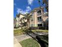 Front view of condo building showcasing landscaping and building features at 4865 Cypress Woods Dr # 2109, Orlando, FL 32811