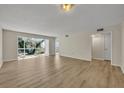 Spacious living room with hardwood floors and large windows at 700 Melrose Ave # A 22, Winter Park, FL 32789