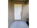 White front door with silver hardware at 7132 Holly Creek Rd, Mount Dora, FL 32757