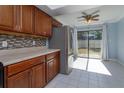 Kitchen with stainless steel refrigerator and sliding glass door to backyard at 7482 Canford Ct # 9, Winter Park, FL 32792